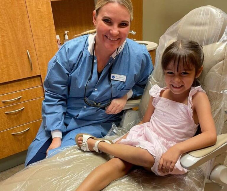 One of our compassionate staff members with a young dental patient